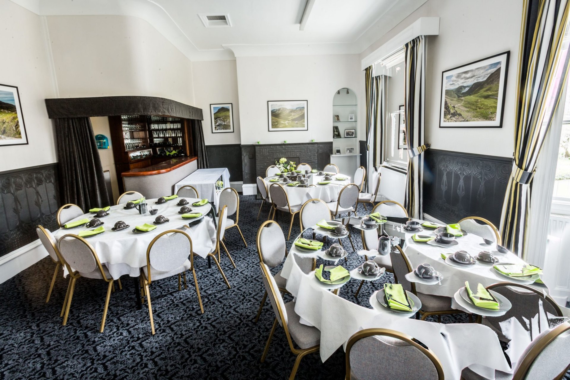 The function room at JW Binks, wood-panelled with round tables set for a wake