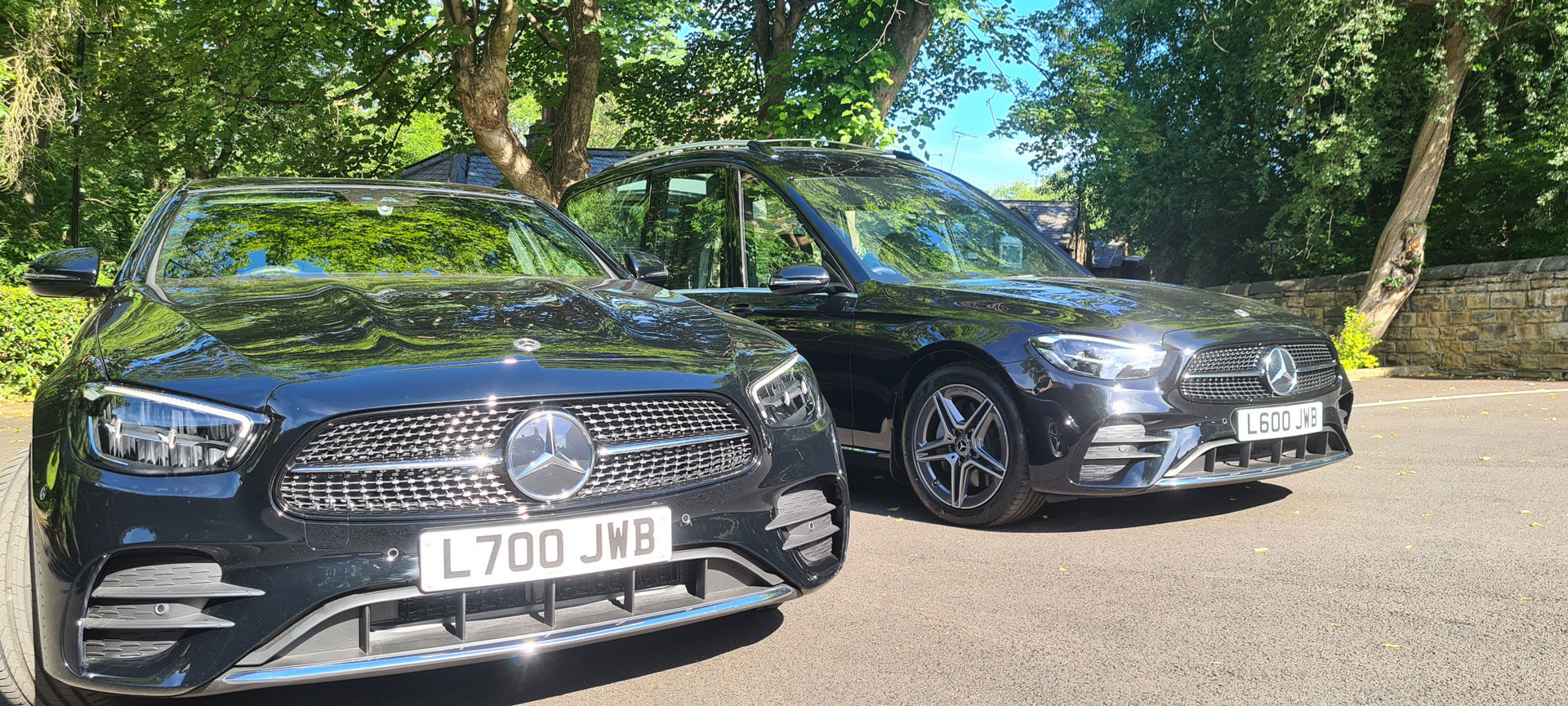 A black Mercedes-Benz hearse from the JW Binks funeral fleet, parked outside Park House